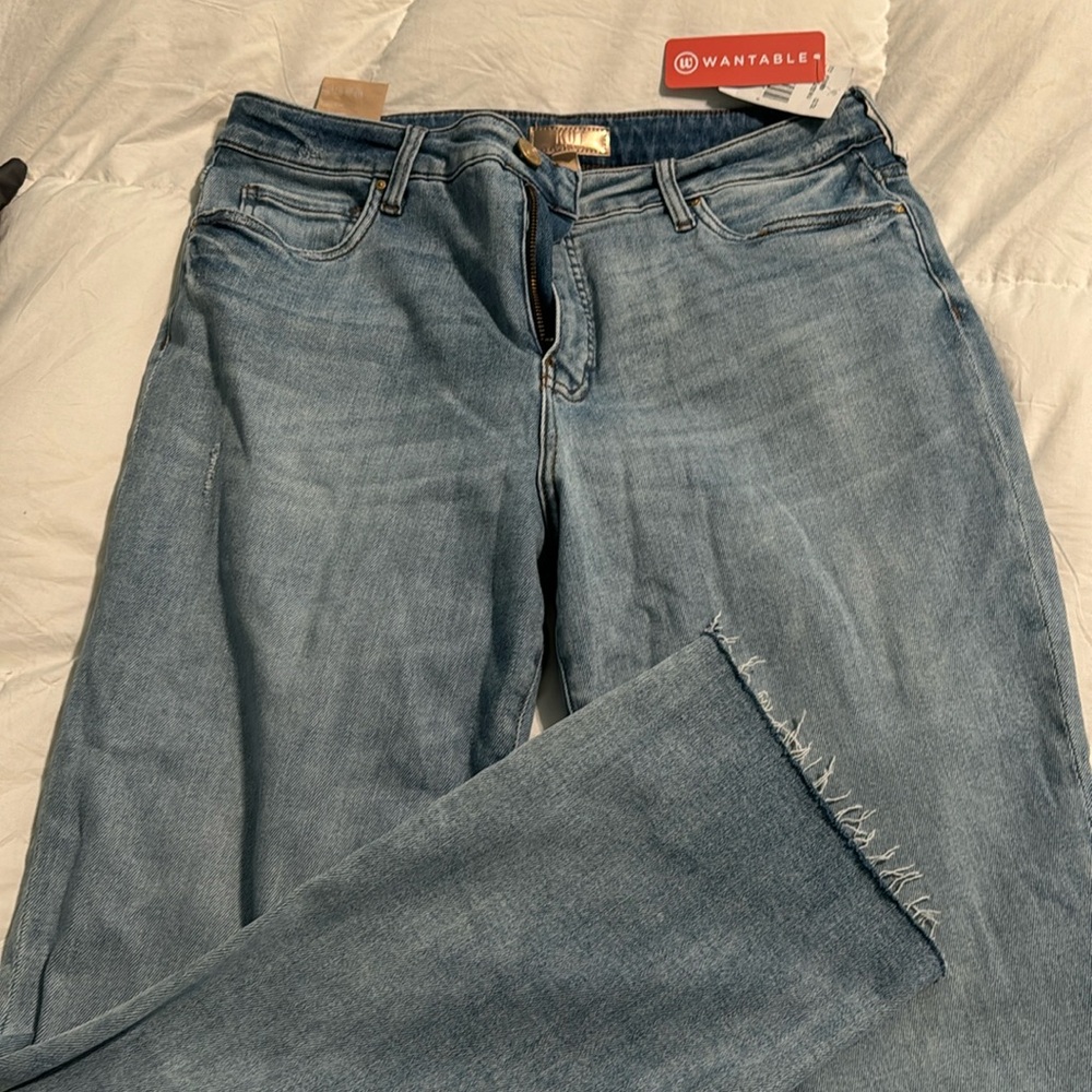 Faded high rise jeans with fringed bottoms